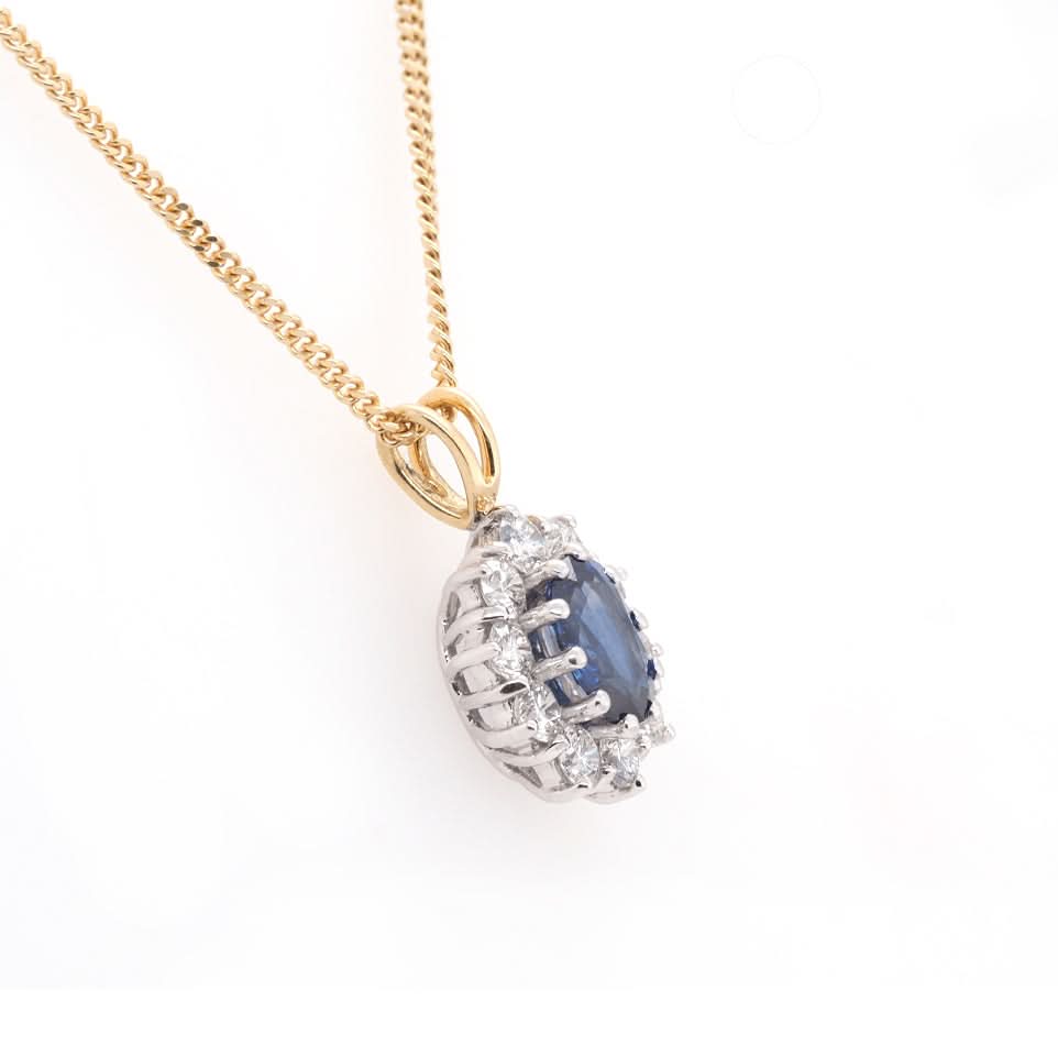 Ogden of Harrogate Jewellery 18ct Yellow Gold Oval Sapphire and Diamond Surround Cluster Pendant on 18ct Yellow Gold Chain