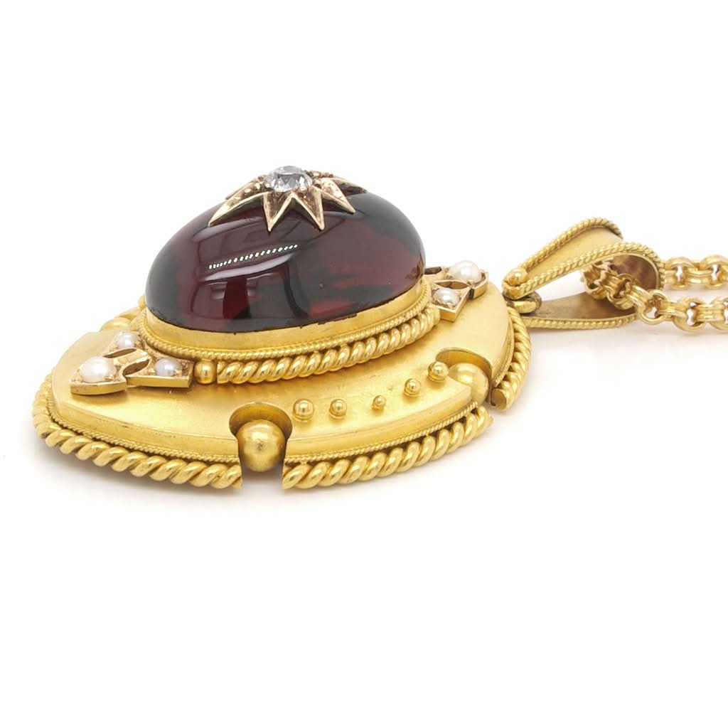 Ogden of Harrogate Jewellery A Victorian Ornate Cabochon Garnet and Gold Pendant, c.1880