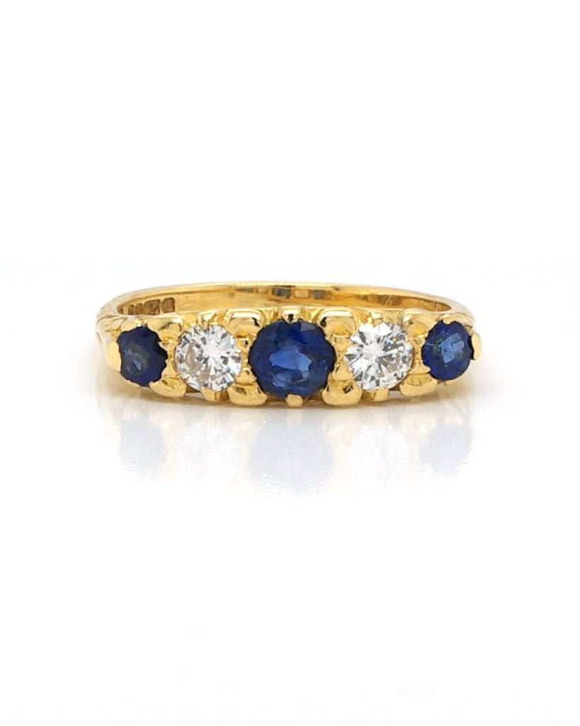 Ogden of Harrogate Jewellery An 18ct Gold, Sapphire and Diamond Five Stone Ring in Carved Setting