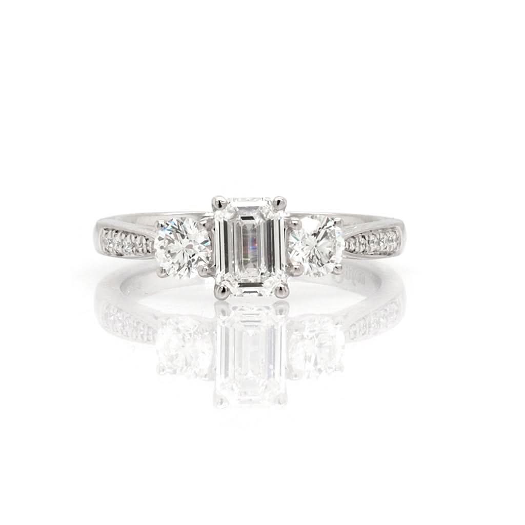 Ogden of Harrogate Jewellery Platinum Emerald Cut and Brilliant Cut Diamond Three Stone Ring with Diamond-set Shoulders, Centre 0.70cts G VS2