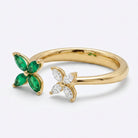 Ogden Of Harrogate 18CT YELLOW GOLD EMERALD AND DIAMOND DOUBLE FLOWER RING.