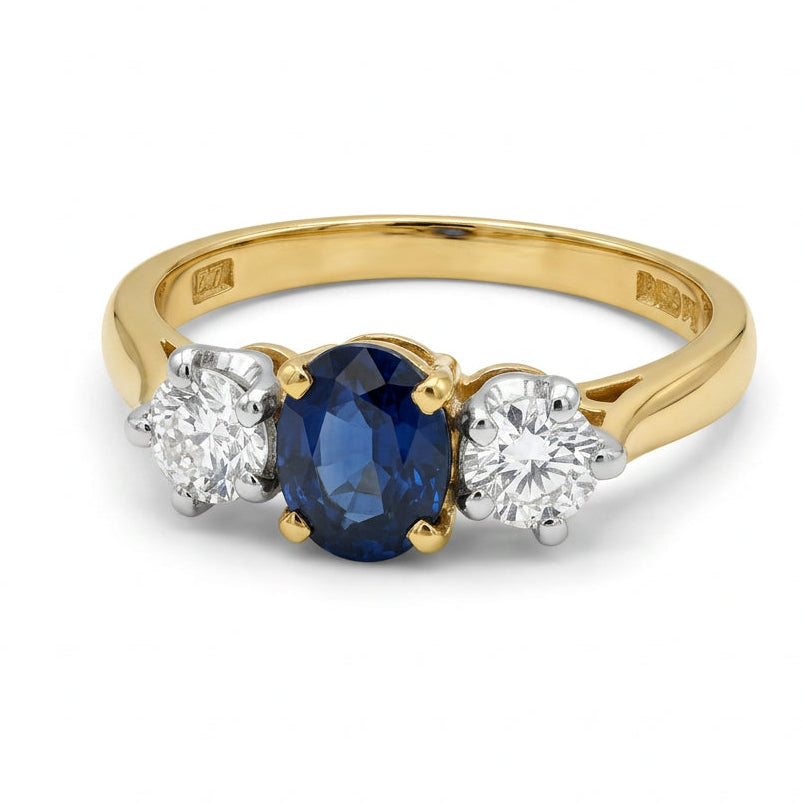Ogden Of Harrogate Jewellery An 18ct Yellow and White Gold Oval Sapphire and Diamond Three Stone Ring