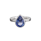Ogden of Harrogate Jewellery A platinum and collet-set pear shaped tanzanite ring with baguette diamond-set shoulders