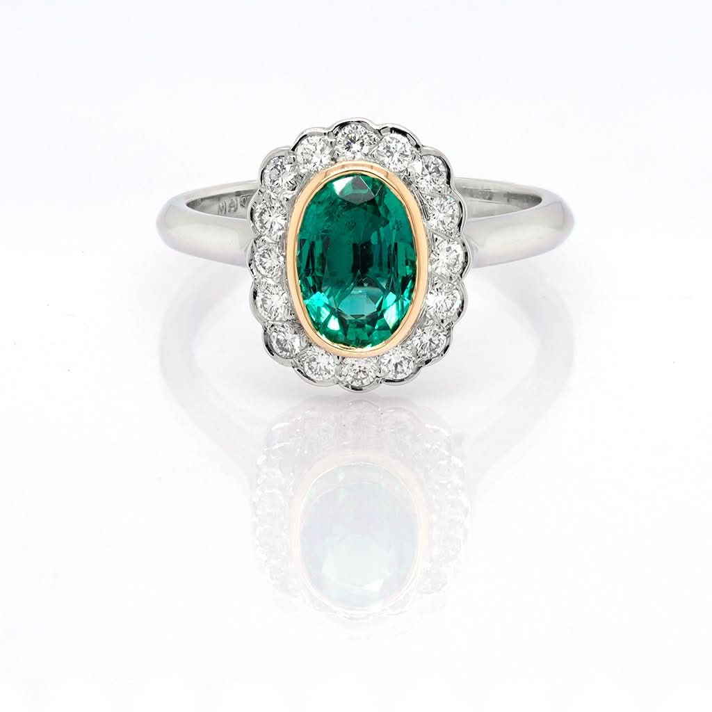 Ogden of Harrogate Jewellery A Platinum, Emerald and Diamond Cluster Ring