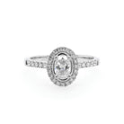 Ogden of Harrogate Jewellery A Platinum Oval Diamond Cluster Ring with Diamond Shoulders