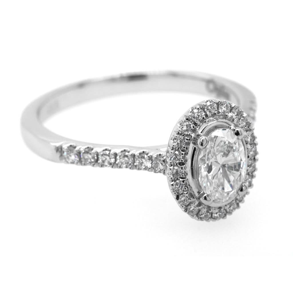 Ogden of Harrogate Jewellery A Platinum Oval Diamond Cluster Ring with Diamond Shoulders