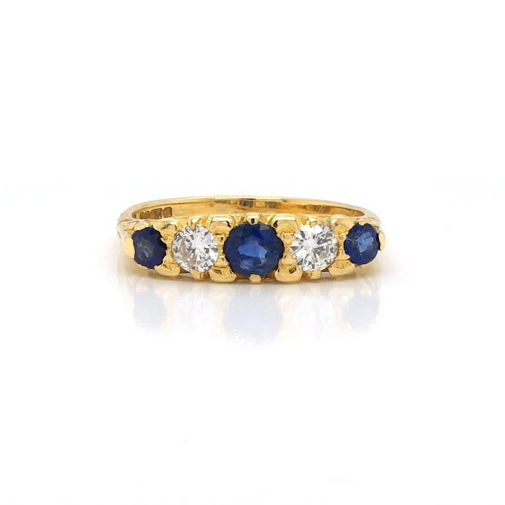 Ogden of Harrogate Jewellery An 18ct Gold, Sapphire and Diamond Five Stone Ring in Carved Setting